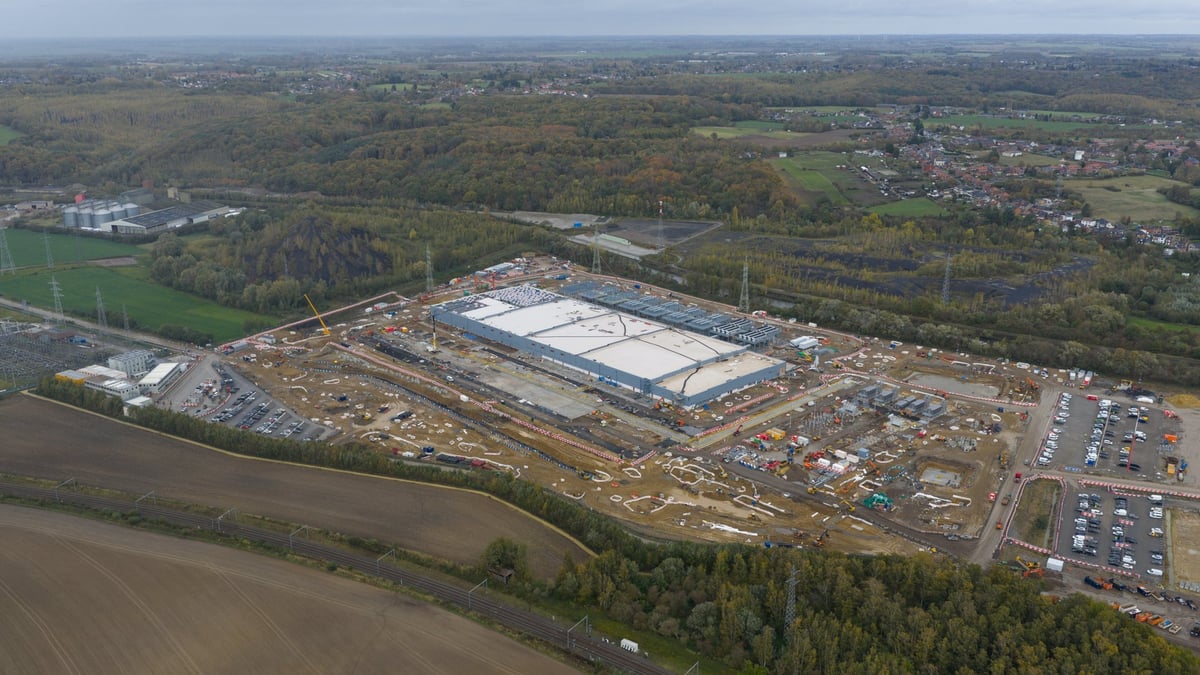 Large new data center construction in Farciennes, Belgium, focusing on AI, digitization, and sustainable expansion. Aerial drone video.